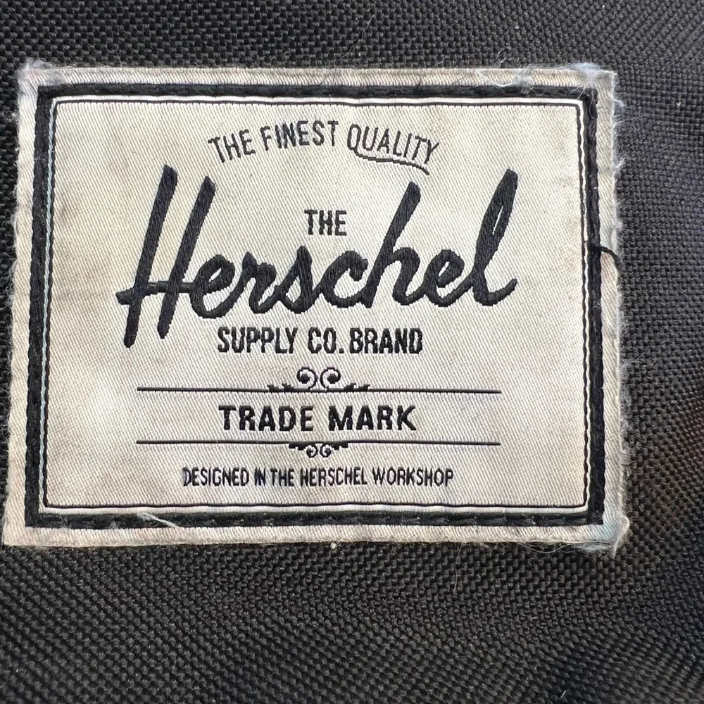 Herschel Supply Co. Pop Quiz backpack in a red and black buffalo plaid pattern.